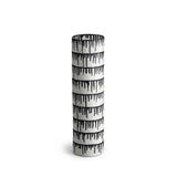 A handmade porcelain vase with indigo dye drops to flowing down from the rim.