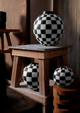 black and white orbs with checkerboard pattern on wood tabletops