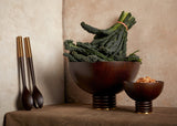 Set of 2 Alhambra hand-carved, fine smoked ash bowls floating on stacked wood pedestal with a brass base. Alhambra serving utensil set.