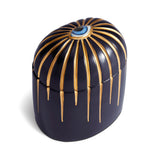 Dark blue cylinder candle with gold details dripping from top eye motif
