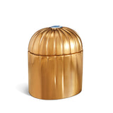 gold cylinder candle posed from side to show gold drip details from eye motif
