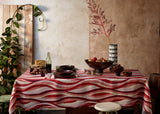 Tabletop set with linen sateen landscape tablecloth, Alhambra smoked wood bowl, and Tokasu porcelain vase with indigo drop motif